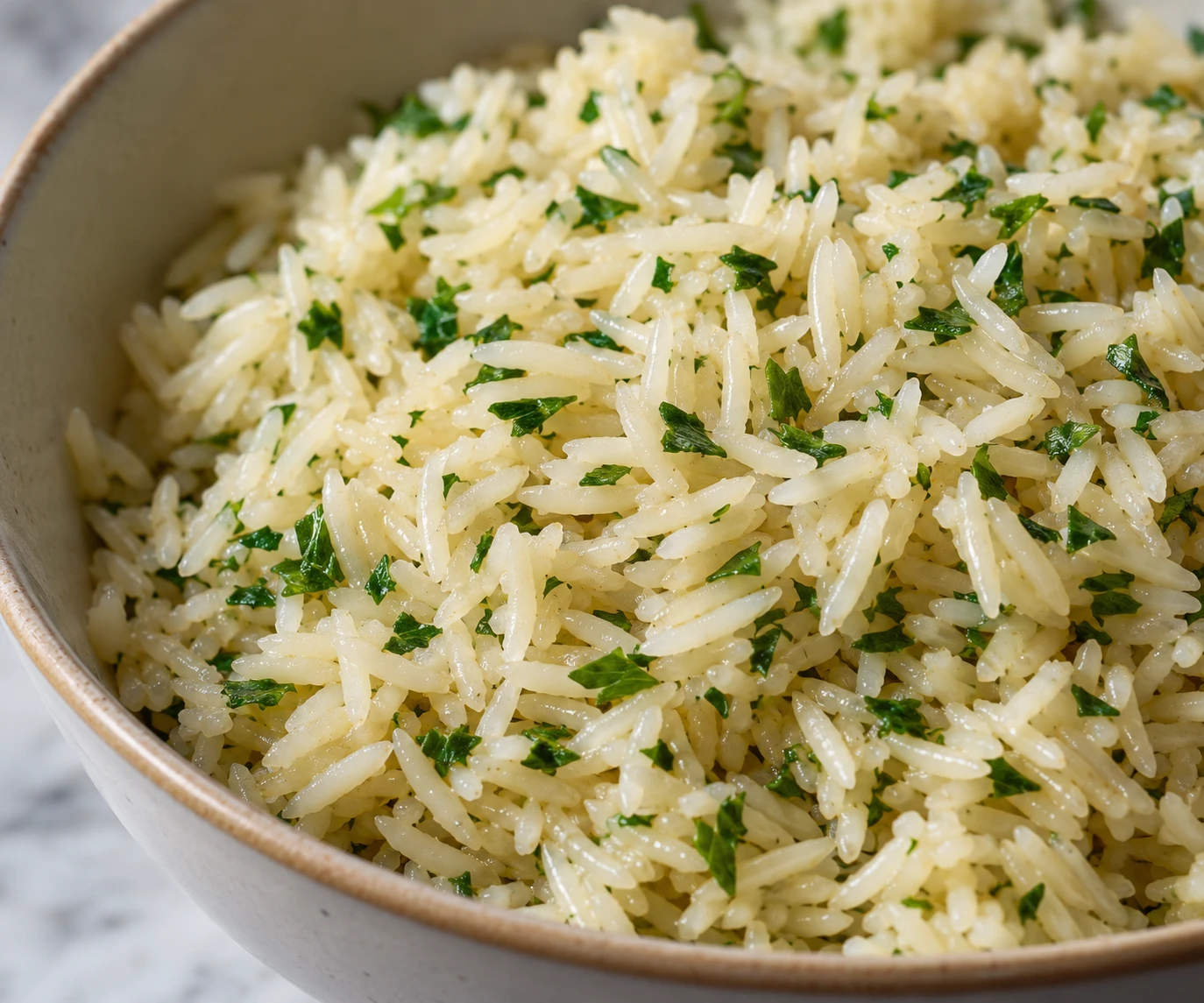 Separate tender rice grains and parsley flecks show the fluffy texture of the finished pilaf.