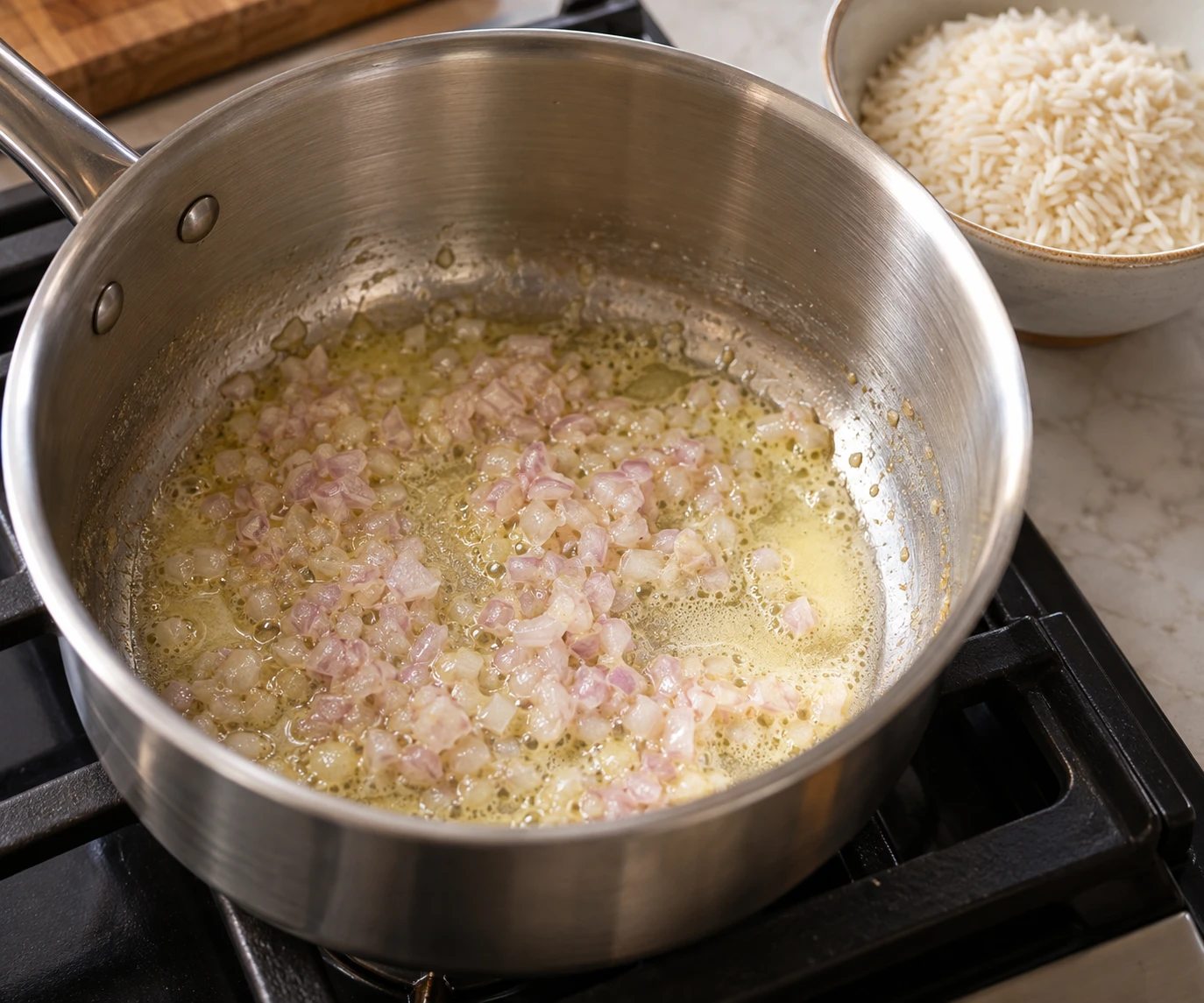 Finely minced shallot softens in pale melted butter in a medium saucepan before rice is added.